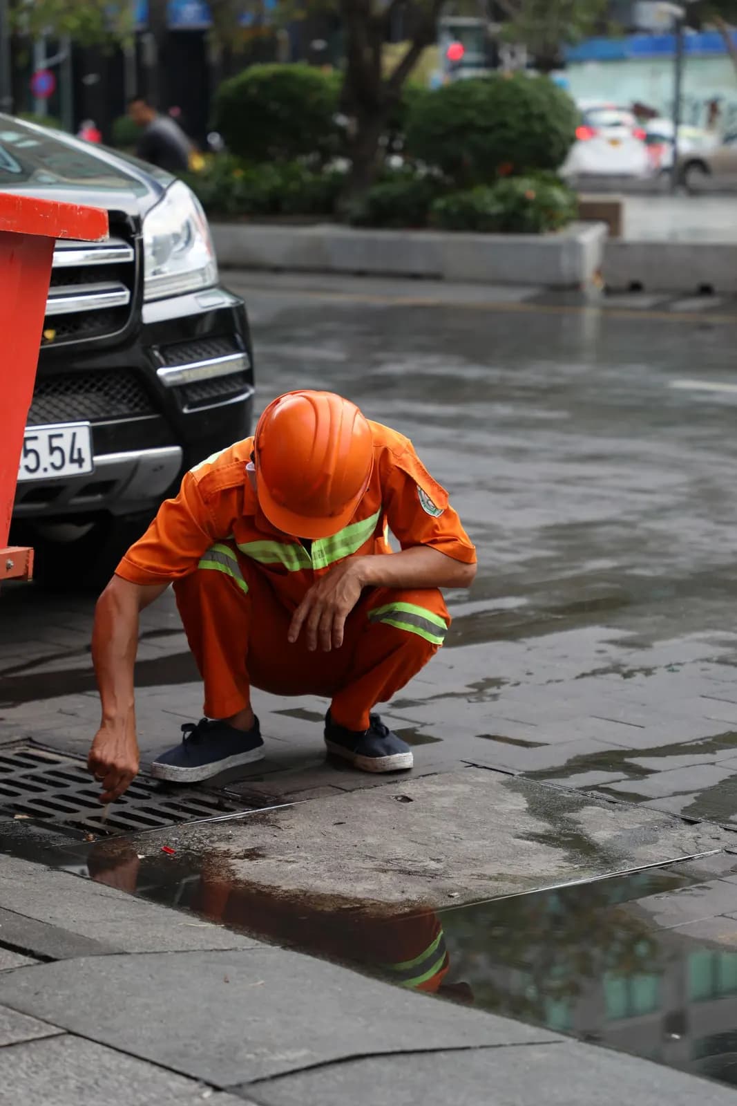Engineer clearing a blocked road gully